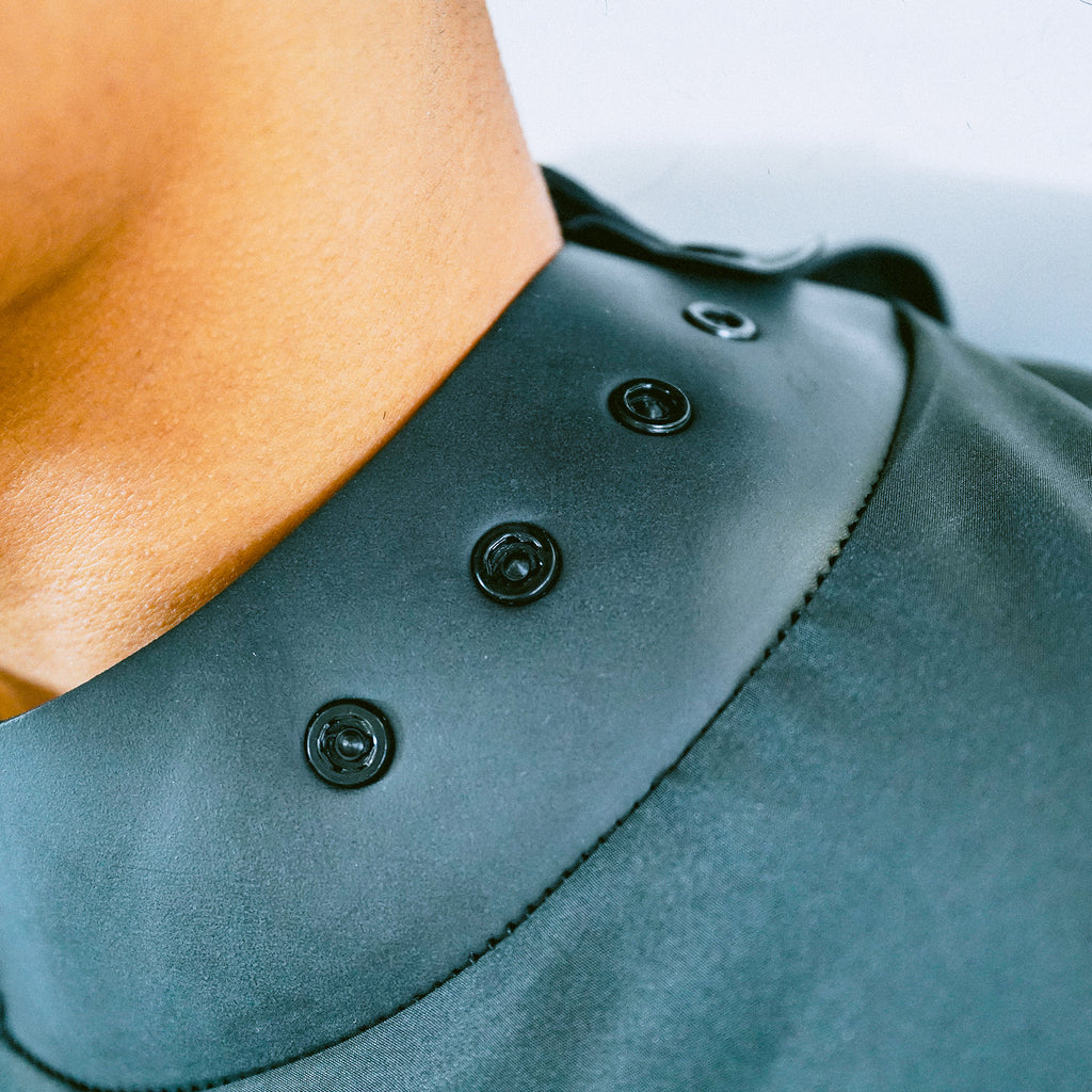 Adjustable strap close-up of a Black Ceremony Stylist Cape
