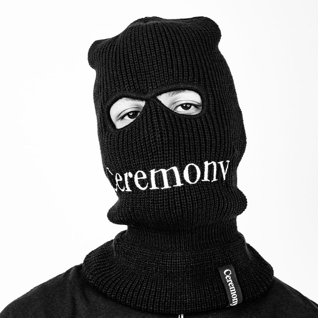 Black and white Photo of Ceremony Black Balaclava on Person From Front View featuring embroidered Ceremony Logo close-up