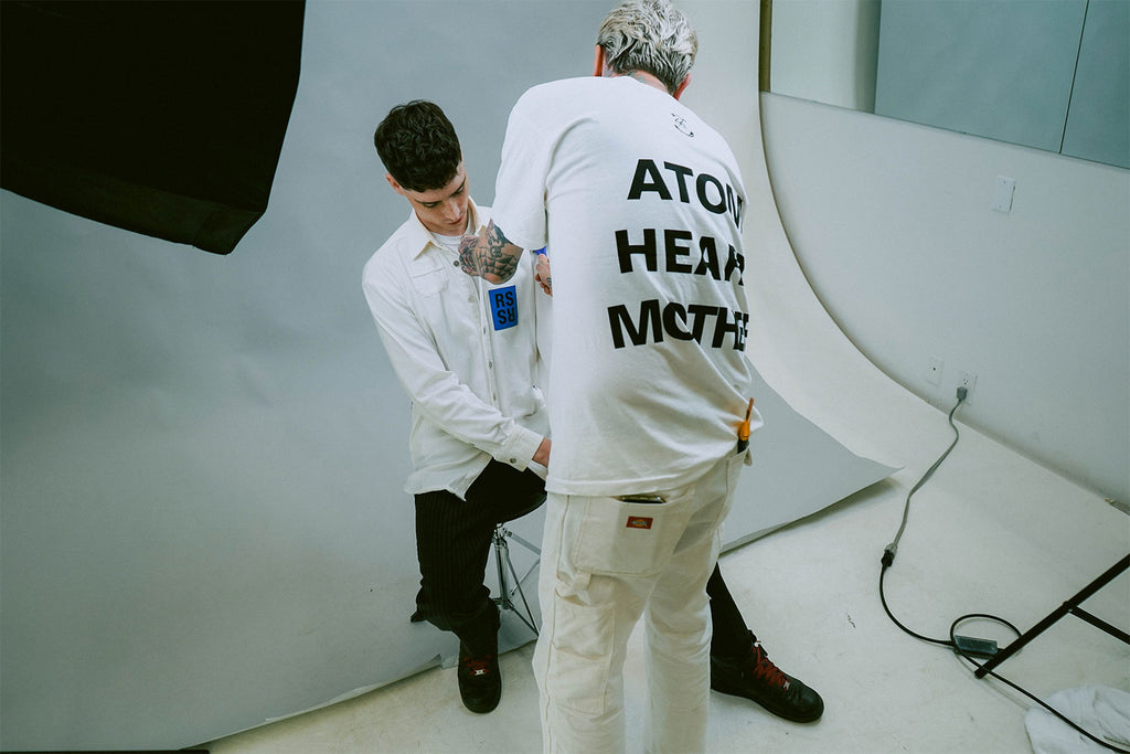 Model with dark texturized haircut styled with Ceremony Disorder Sea Salt Spray being prepared for a photoshoot by stylist
